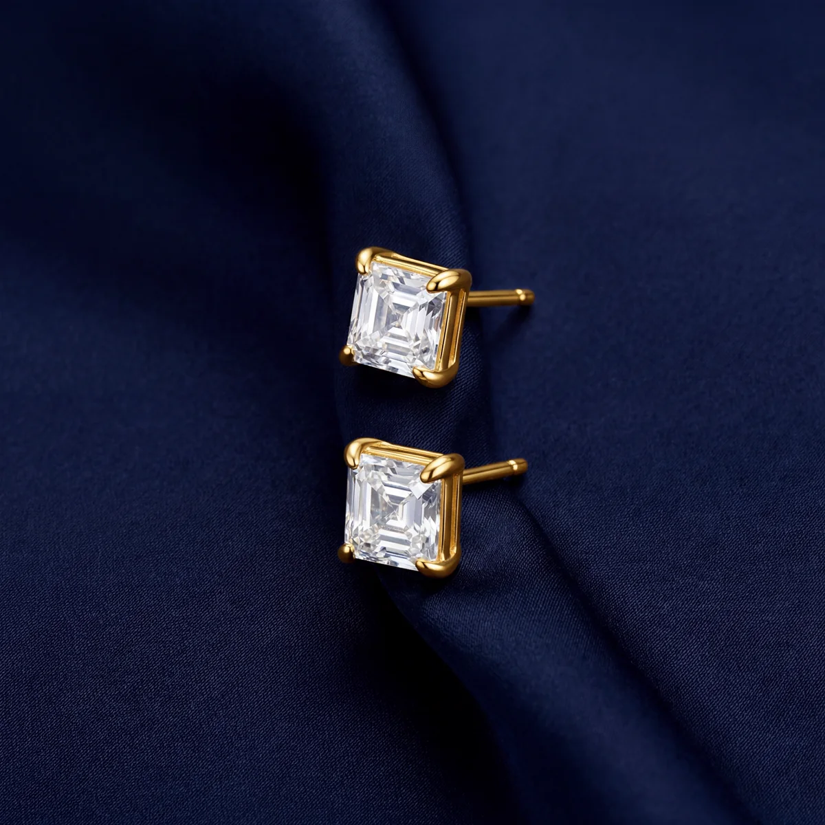 Larensy asscher-cut moissanite stud earrings in gold on midnight-blue satin