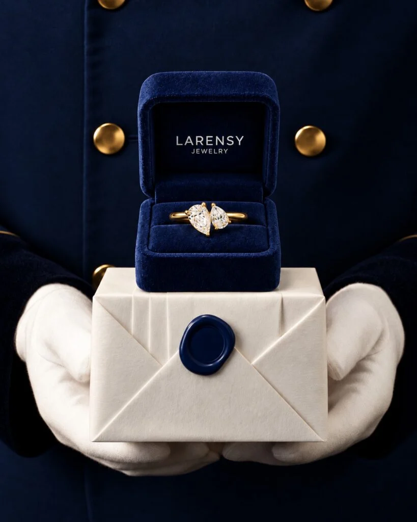 Larensy ring presented in its navy velvet light-up box on a sealed gift parcel